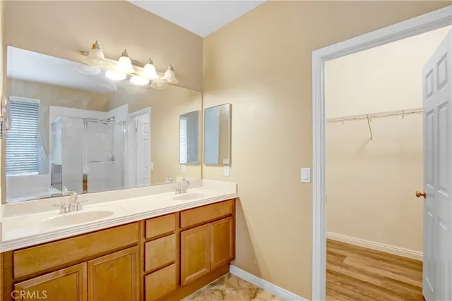 a bathroom with a double vanity sink and a mirror