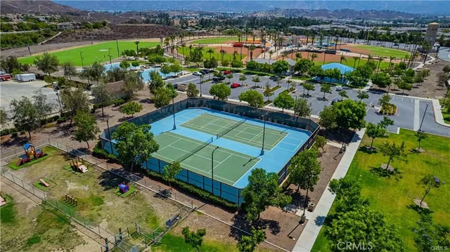an aerial view of a houses with a yard and lake view