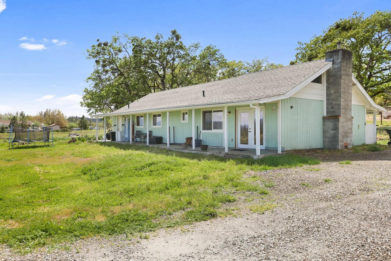 380 Greenleaf Drive Eagle Point, OR 97524 - Photo 1 of 31 a view of a house with backyard and sitting area