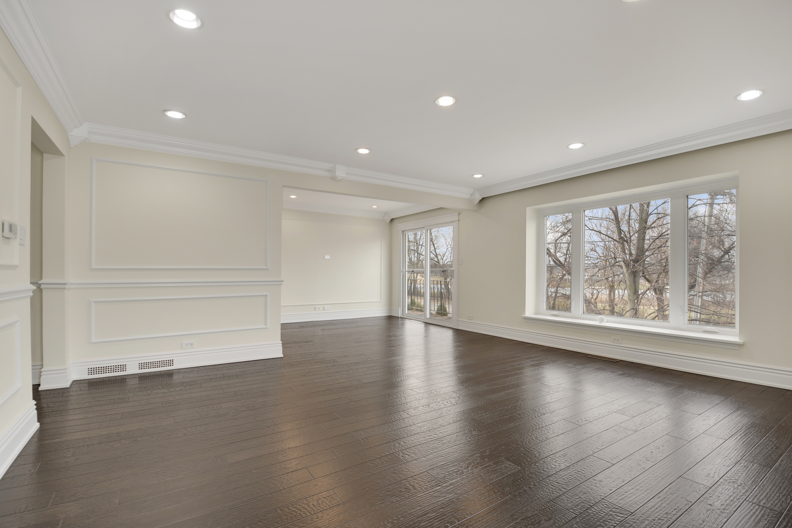 491 Old Surrey Road, Unit B Hinsdale, IL 60521 - Photo 5 of 29 an empty room with wooden floor and windows