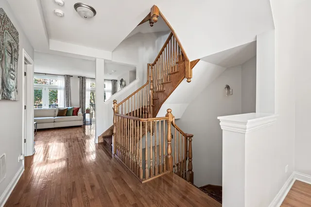 a view of entryway and hall with wooden floor
