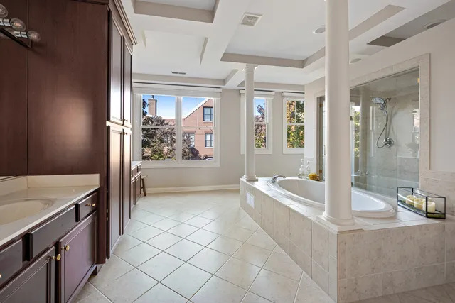 a spacious bathroom with a granite countertop tub sink and mirror
