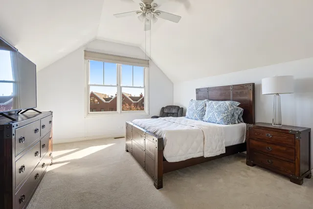 a bedroom with a bed dresser and a window