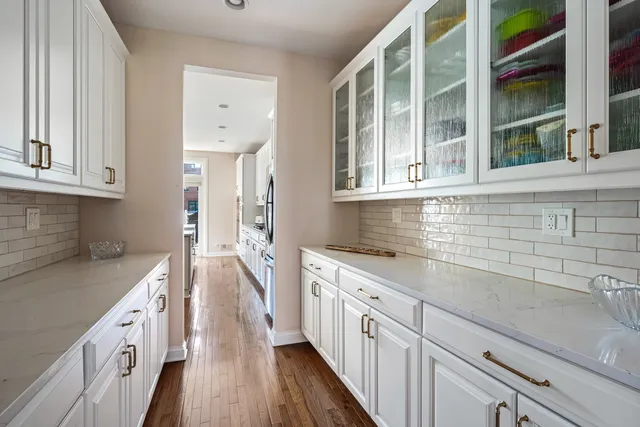 a kitchen with granite countertop a sink stove and cabinets