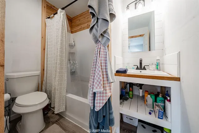 a bathroom with a sink toilet and shower