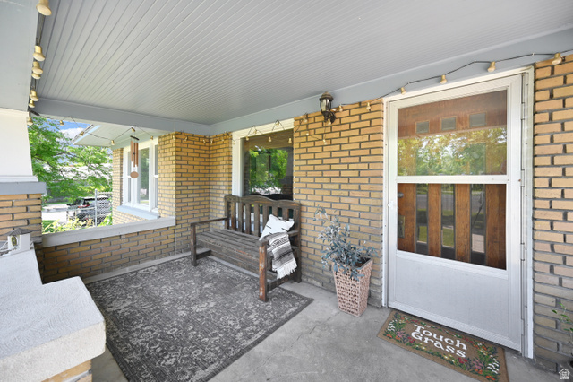 331 West 300 North Logan, UT 84321 - Photo 25 of 28 Covered front porch featuring brick siding, a concrete floor, and a beadboard ceiling