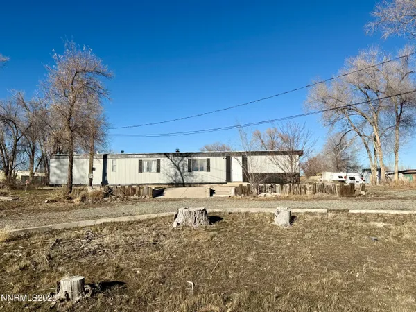 a view of a house with a yard and snow