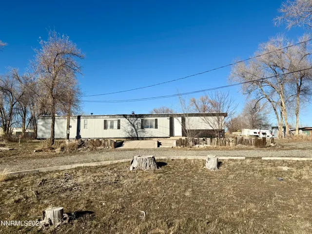 a view of a house with a yard and snow
