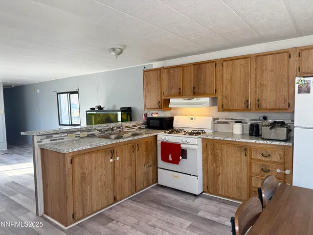 a kitchen with refrigerator and chairs