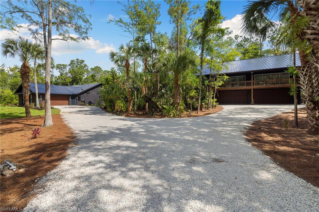 4521 3rd Avenue Northwest Naples, FL 34119 - Photo 30 of 46 a view of a house with backyard and a tree