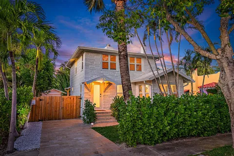 a front view of a house with a garden