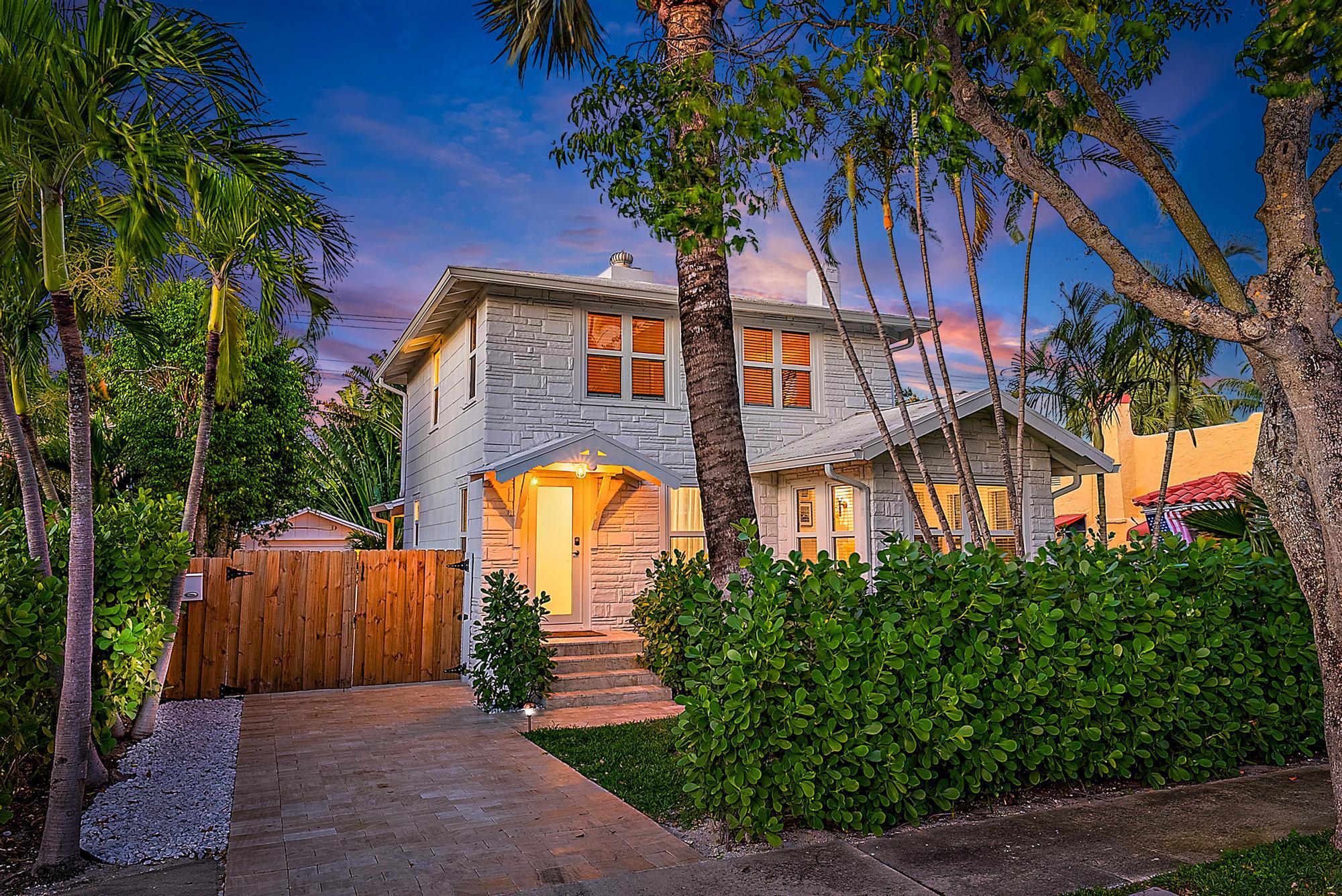a front view of a house with a garden