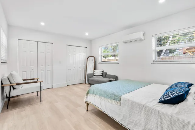 a bedroom with a bed and a painting on the wall