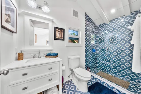 a bathroom with a toilet a sink and a shower curtain