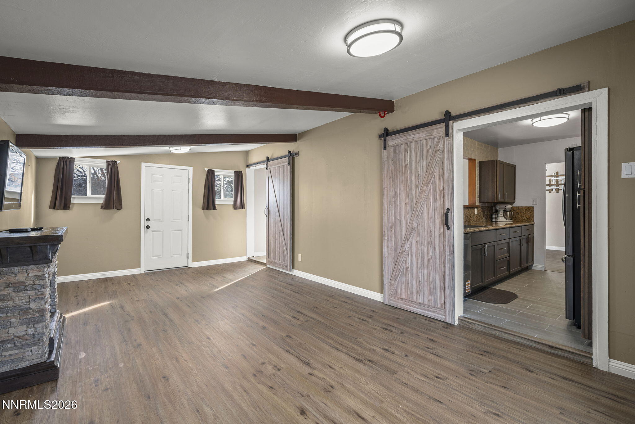 11303 Rocky Mountain Street Reno, NV 89506 - Photo 16 of 28 a view of a hallway with wooden floor and a kitchen