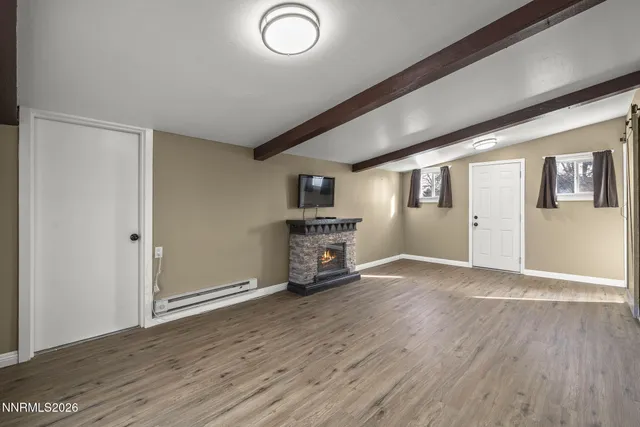 wooden floor in an empty room with a fireplace