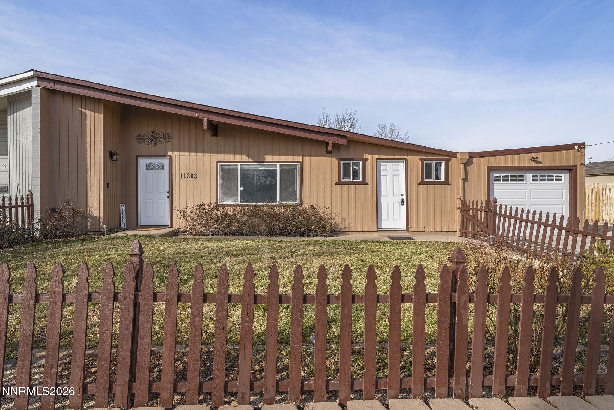 11303 Rocky Mountain Street Reno, NV 89506 - Photo 4 of 28 a front view of a house with a yard
