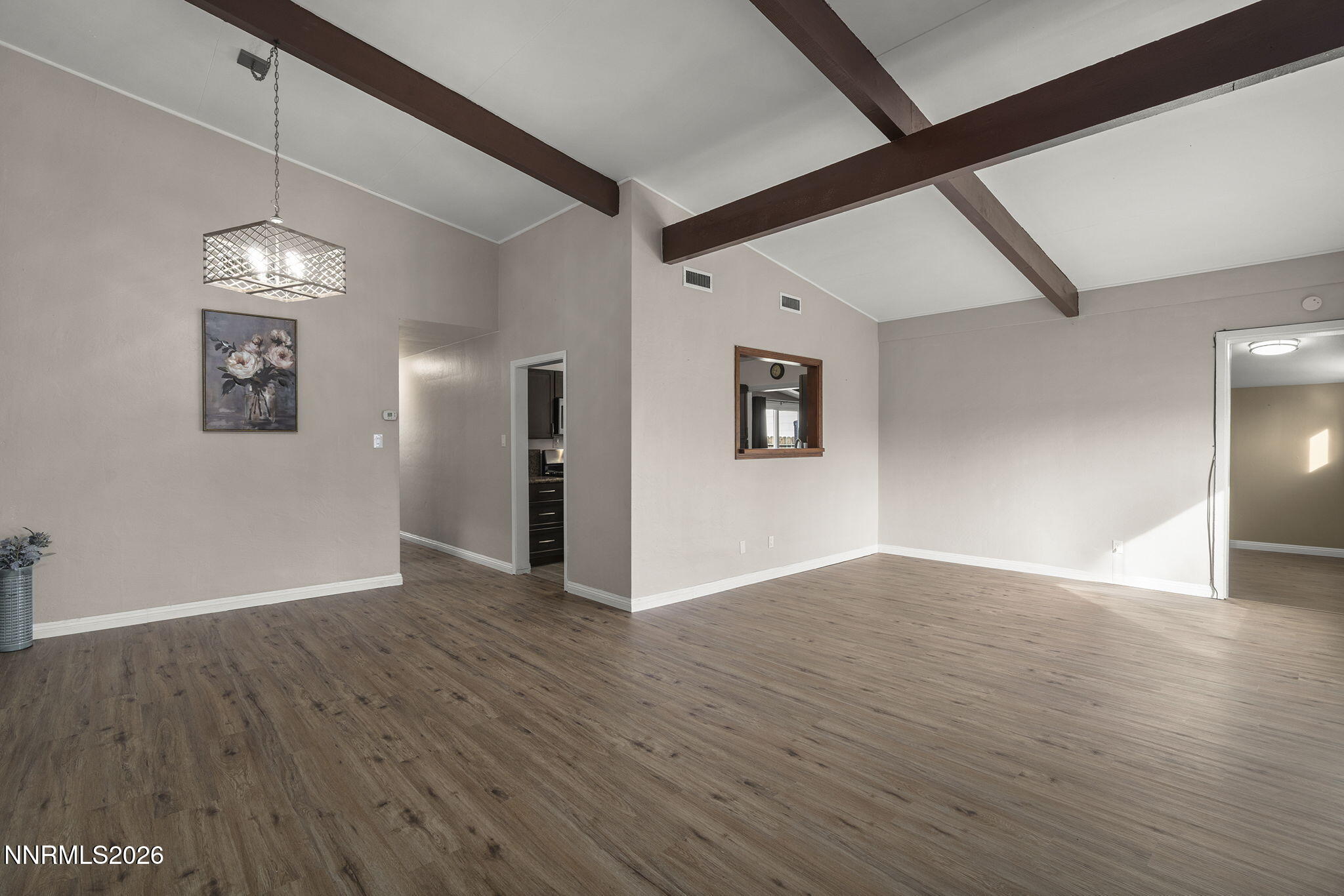 11303 Rocky Mountain Street Reno, NV 89506 - Photo 5 of 28 a view of an empty room with wooden floor and a window
