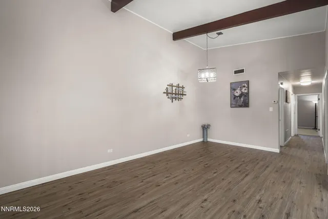 a view of a room with wooden floor