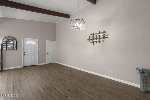a view of a room with wooden floor