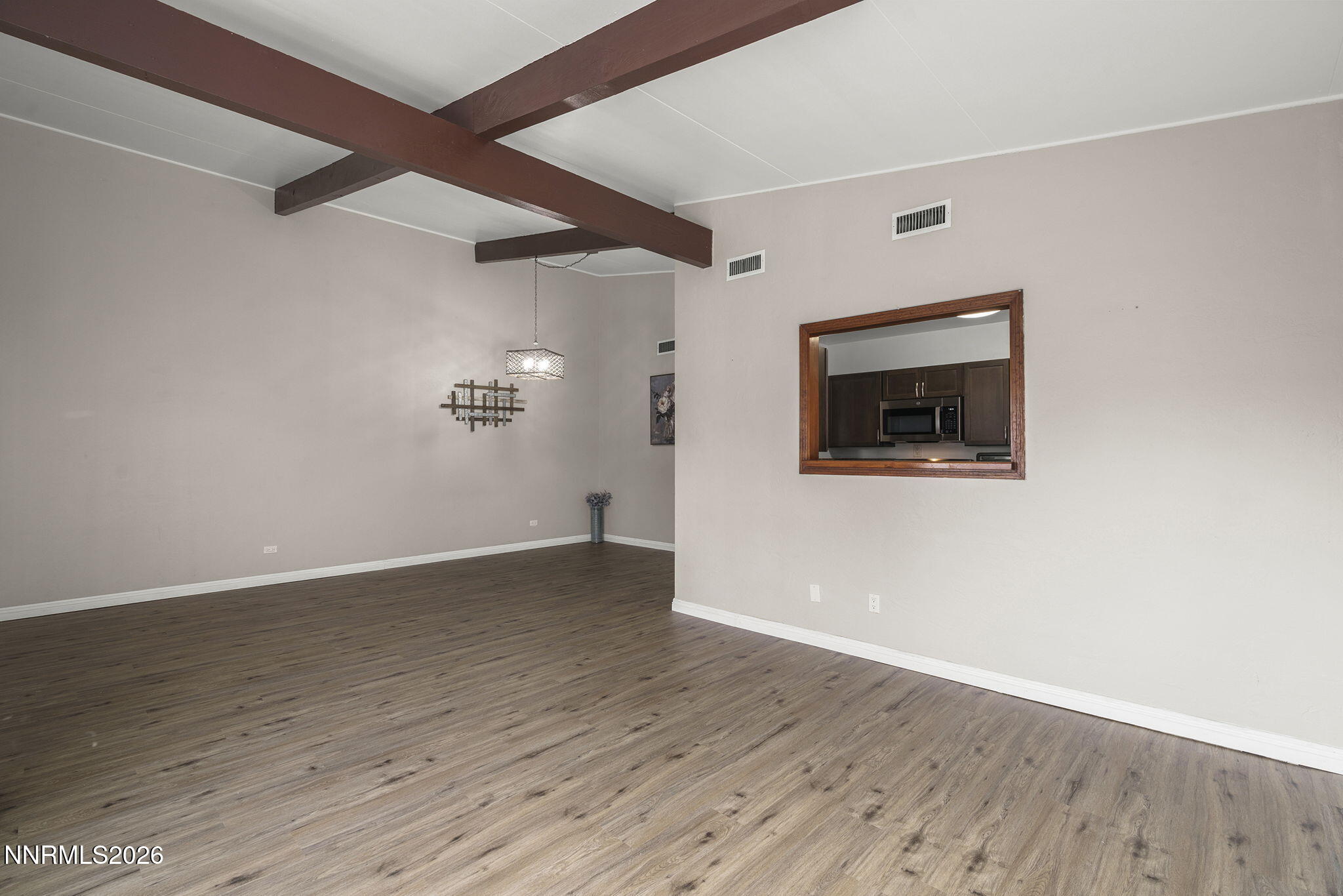 11303 Rocky Mountain Street Reno, NV 89506 - Photo 9 of 28 an empty room with wooden floor and windows