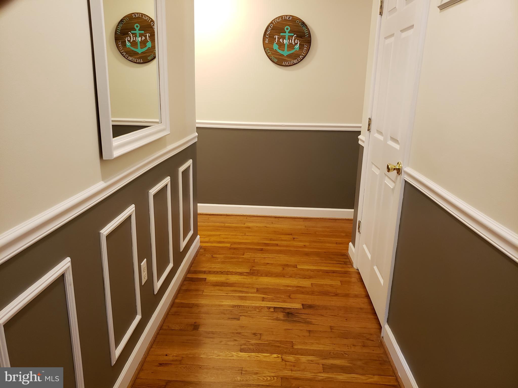 1138 Calvert Beach Road St. Leonard, MD 20685 - Photo 9 of 17 foyer with shadow boxing and chair rails.