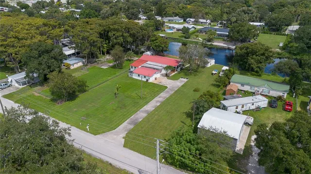 an aerial view of a house with garden space lake view and ocean view