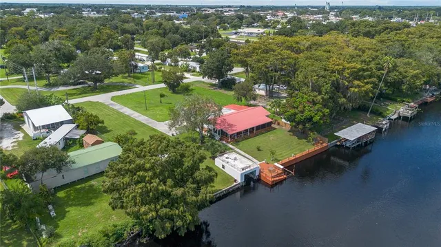 an aerial view of a house with a yard lake lake view and mountain view