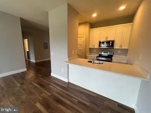 a kitchen with stainless steel appliances a refrigerator a stove a microwave and cabinets