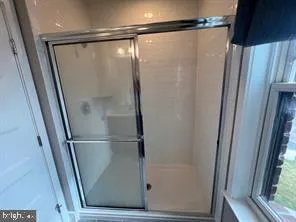 a bathroom with a glass shower door
