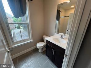 228 South Mill Road, Unit 232 Kennett Square, PA 19348 - Photo 12 of 12 a bathroom with a sink a toilet and a mirror
