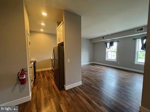 228 South Mill Road, Unit 232 Kennett Square, PA 19348 - Photo 4 of 12 a view of a room with wooden floor and a window