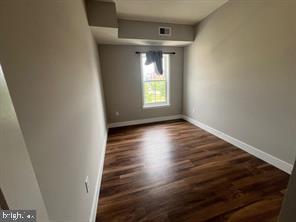 228 South Mill Road, Unit 232 Kennett Square, PA 19348 - Photo 6 of 12 a view of an empty room with wooden floor and a window
