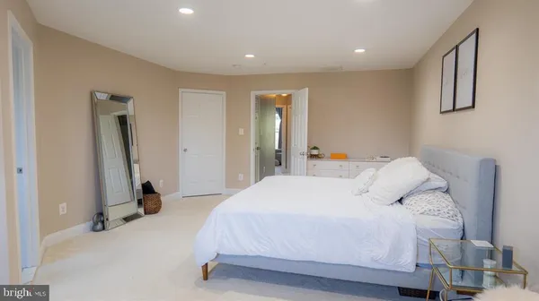 a bedroom with a bed and a mirror