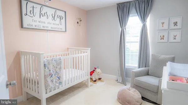 a bedroom with furniture and a large window