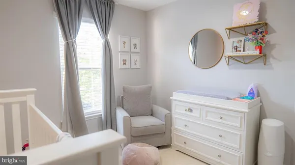 a living room with furniture and a mirror