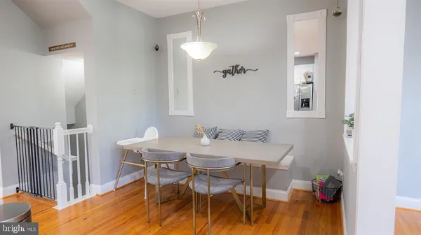 a view of a dining room with furniture and wooden floor
