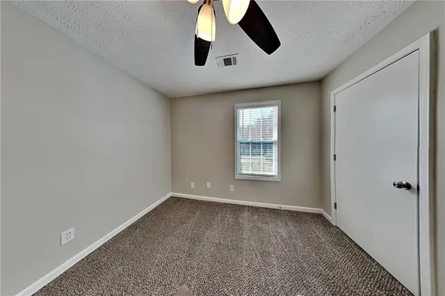 an empty room with windows and entrance