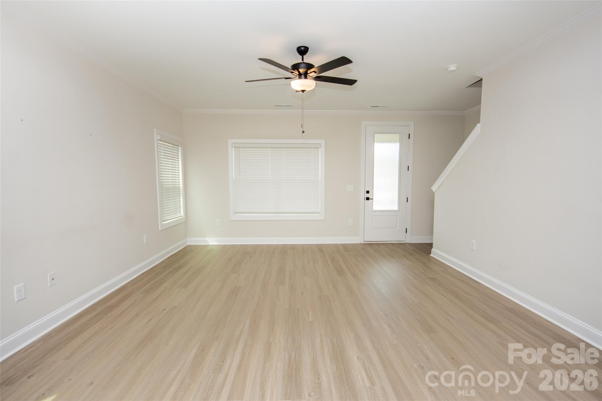 109 Brixham Loop Troutman, NC 28166 - Photo 14 of 44 wooden floor in an empty room with a window