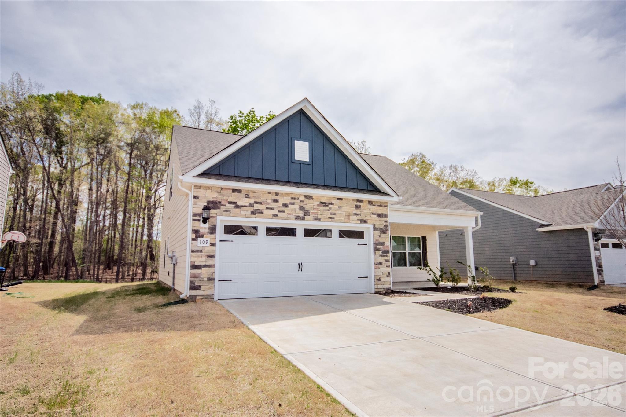 109 Brixham Loop Troutman, NC 28166 - Photo 2 of 44 a front view of a house with a garage
