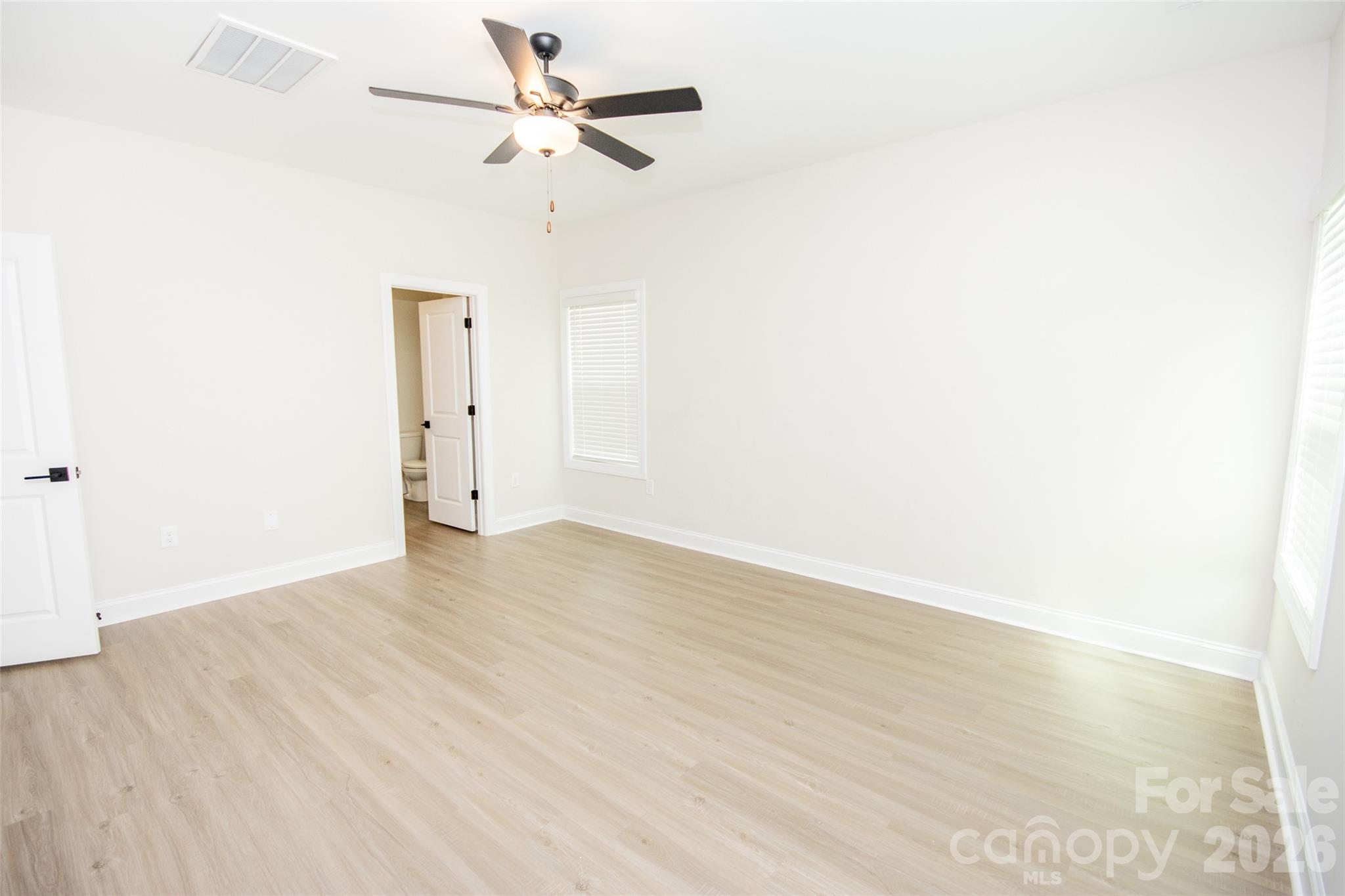 109 Brixham Loop Troutman, NC 28166 - Photo 25 of 44 a view of empty room with wooden floor