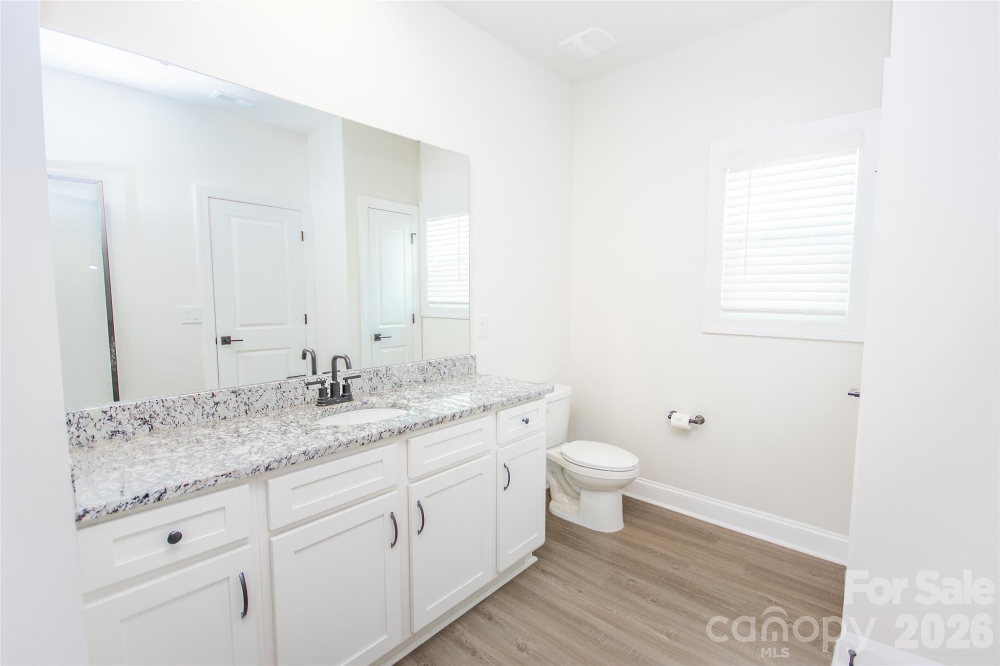 109 Brixham Loop Troutman, NC 28166 - Photo 29 of 44 a bathroom with a granite countertop sink and a mirror
