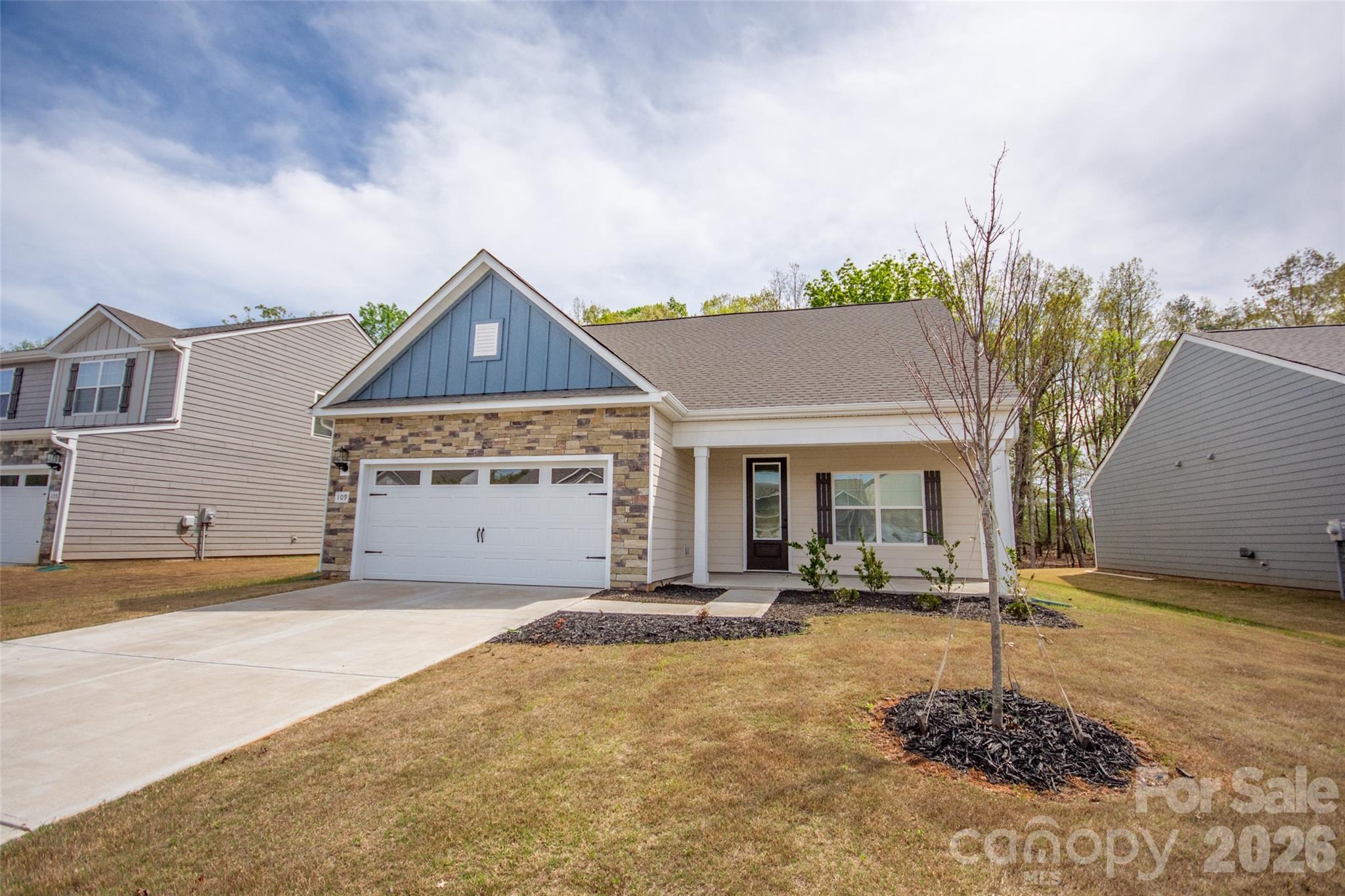 109 Brixham Loop Troutman, NC 28166 - Photo 3 of 44 a front view of a house with a yard