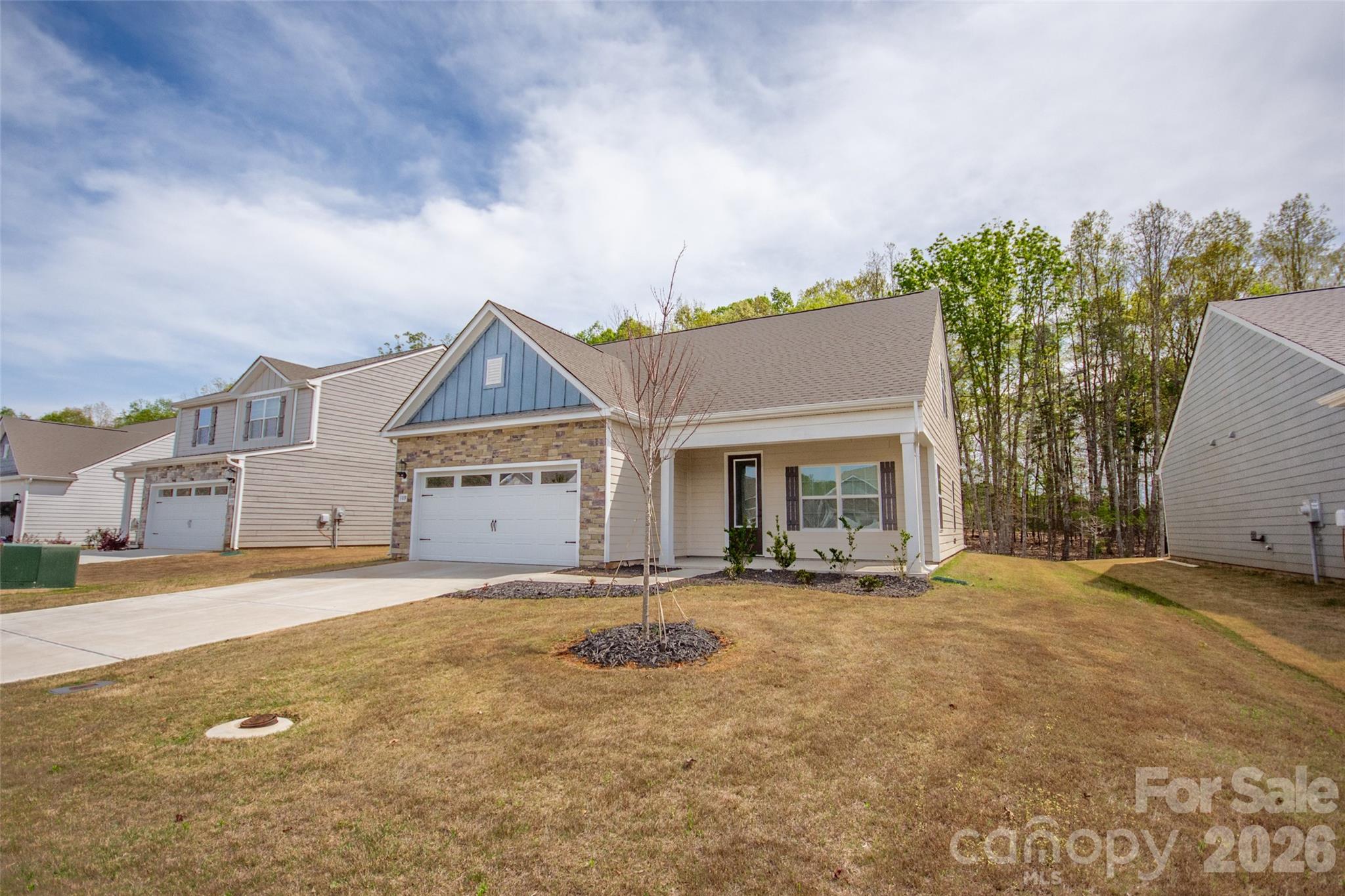 109 Brixham Loop Troutman, NC 28166 - Photo 5 of 44 front view of a house with a big yard