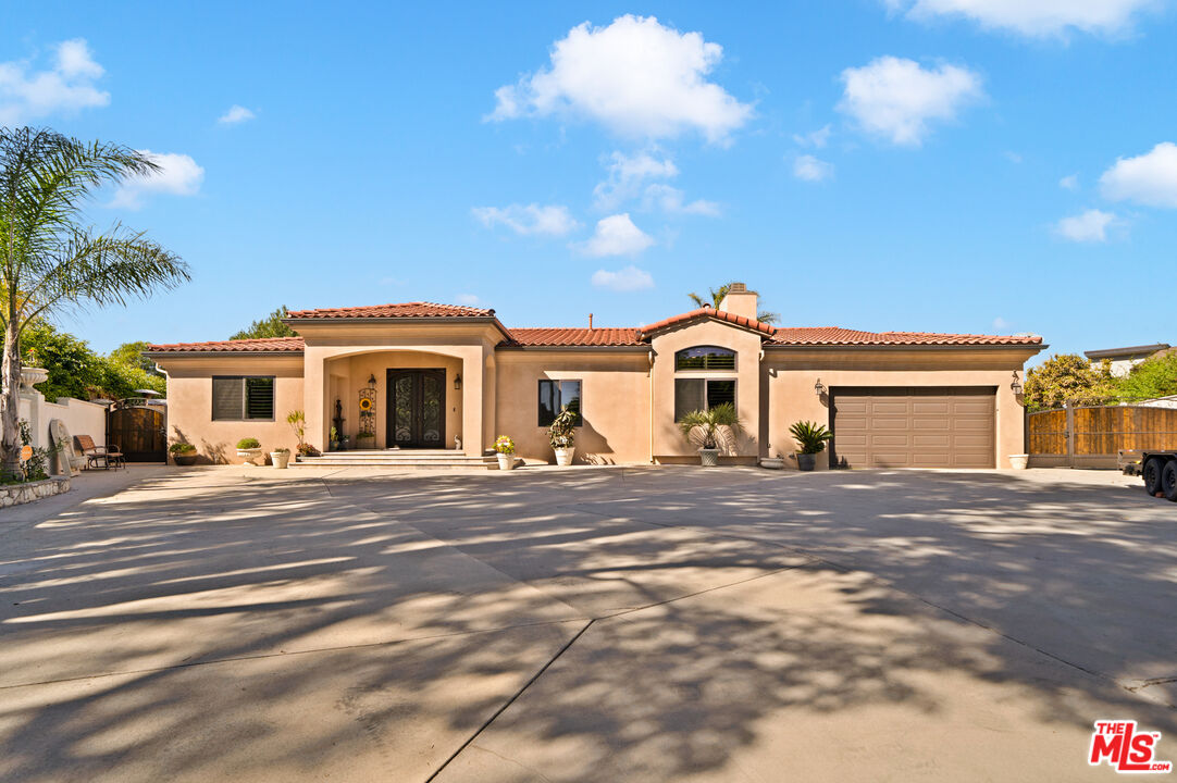 5437 Middlecrest Road Rancho Palos Verdes, CA 90275 - Photo 1 of 32 a front view of a house with a yard and garage