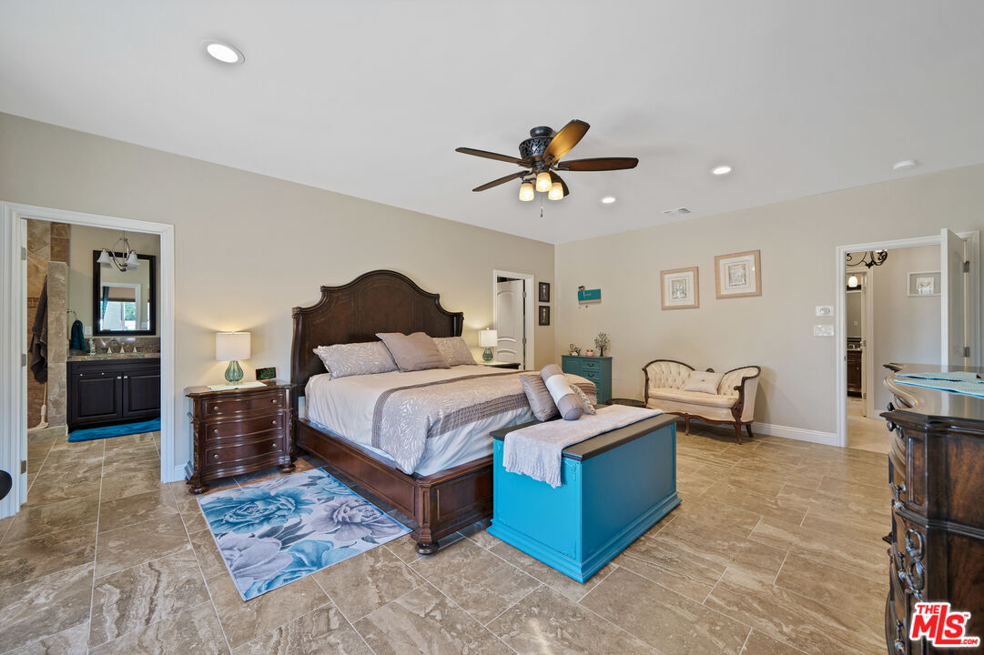 5437 Middlecrest Road Rancho Palos Verdes, CA 90275 - Photo 13 of 32 a bedroom with a bed a couch and a chandelier