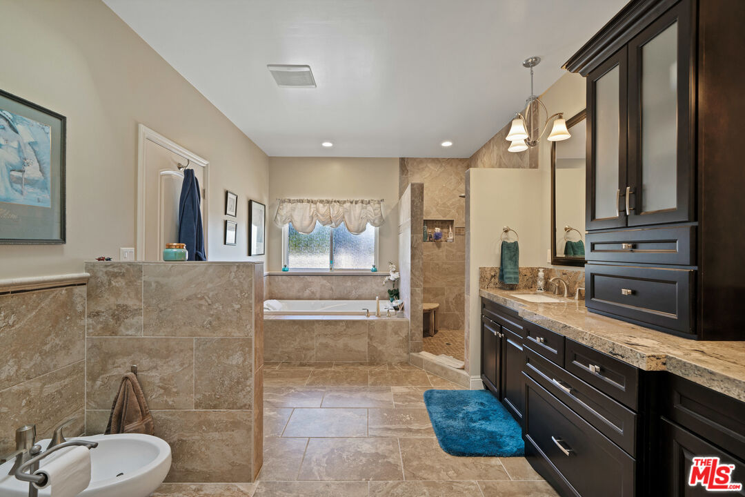 5437 Middlecrest Road Rancho Palos Verdes, CA 90275 - Photo 15 of 32 a large bathroom with a granite countertop sink a toilet a mirror and shower