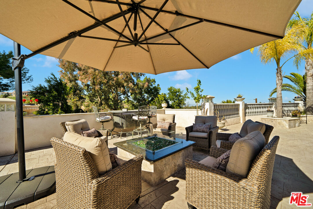 5437 Middlecrest Road Rancho Palos Verdes, CA 90275 - Photo 21 of 32 a balcony with furniture and umbrella