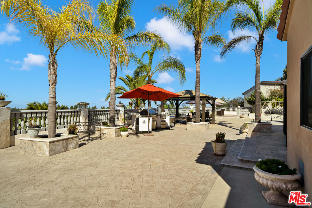 5437 Middlecrest Road Rancho Palos Verdes, CA 90275 - Photo 22 of 32 a row of palm trees and swimming pool in the backyard of a house