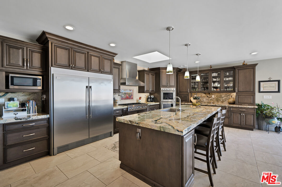 5437 Middlecrest Road Rancho Palos Verdes, CA 90275 - Photo 3 of 32 a kitchen with stainless steel appliances granite countertop a sink a stove and a refrigerator